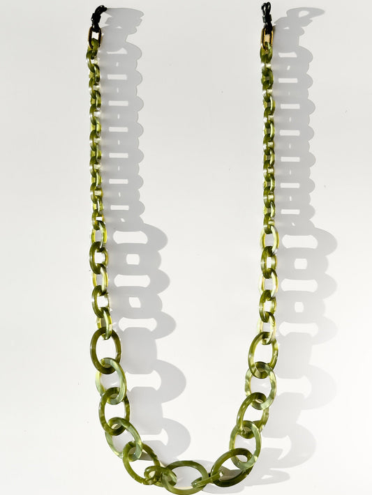 Green glasses chain necklace on a white background