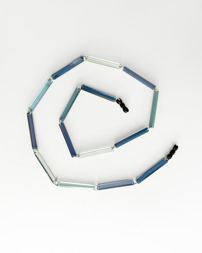 Hexagonal modular toy with blue and clear segments on a white background glasses chain
