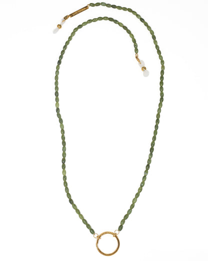 An olive green faceted bead necklace with a gold circular ring pendant and gold-toned clasp, displayed on a clean white background.